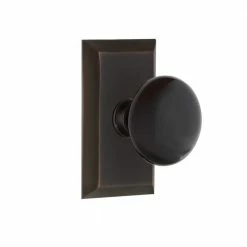 Nostalgic Warehouse Studio Plate 2-3/8 in. Backset Timeless Bronze Passage Hall/Closet Black Porcelain Door Knob