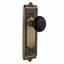 Nostalgic Warehouse Egg and Dart Plate 2-3/8 in. Backset Antique Brass Passage Hall/Closet Black Porcelain Door Knob