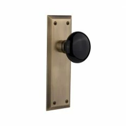 Nostalgic Warehouse New York Plate 2-3/4 in. Backset Antique Brass Privacy Bed/Bath Black Porcelain Door Knob