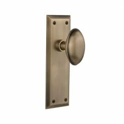 Nostalgic Warehouse New York Plate 2-3/8 in. Backset Antique Brass Privacy Bed/Bath Homestead Door Knob